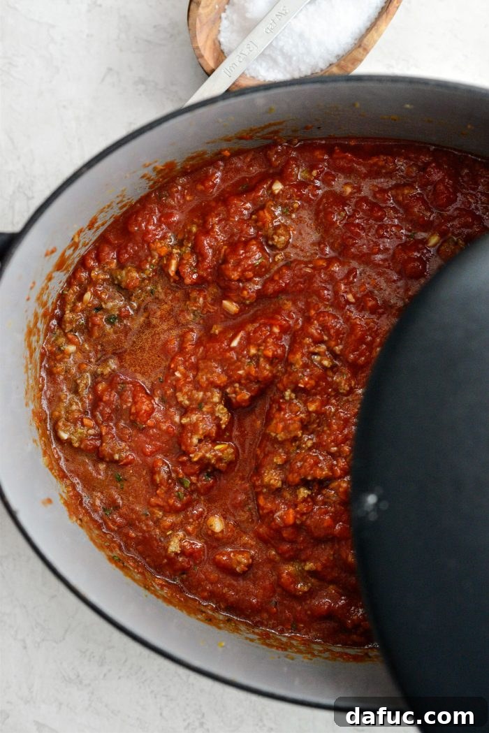 Slow Roasted Spaghetti Sauce 14 Dutch oven covered and baking in the oven.