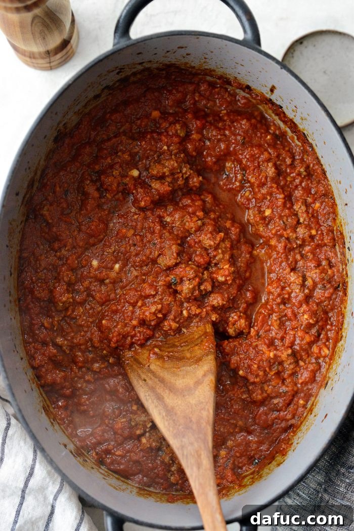 Slow Roasted Spaghetti Sauce 15 Stirring the slow baked spaghetti sauce after it has been removed from the oven.