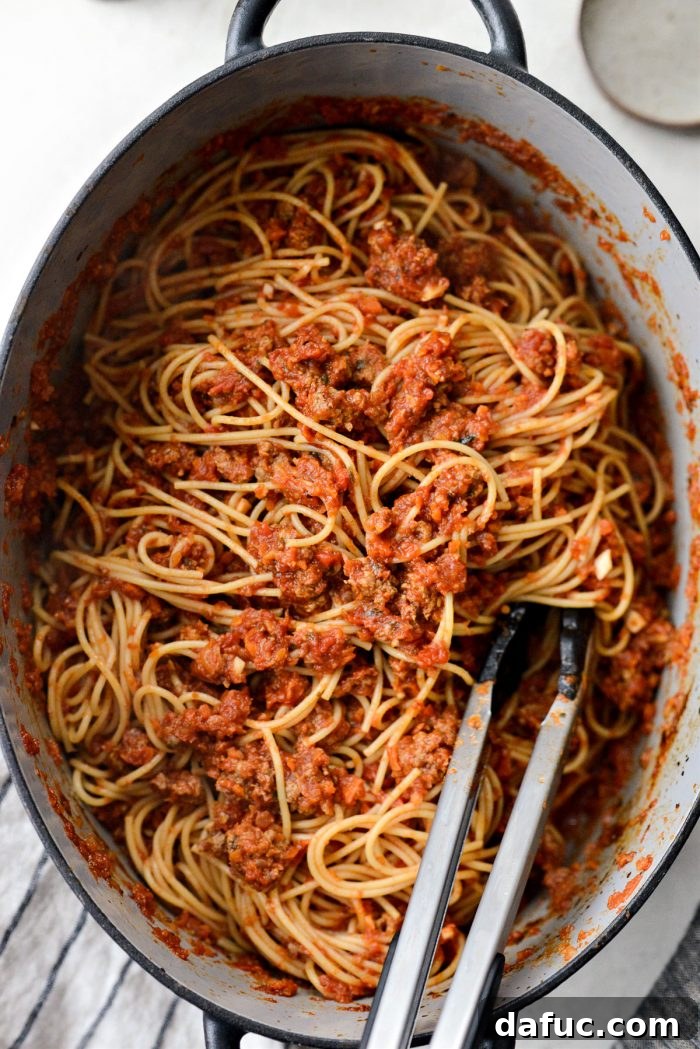Slow Roasted Spaghetti Sauce 17 Tossing cooked spaghetti with the rich slow baked sauce in a Dutch oven.