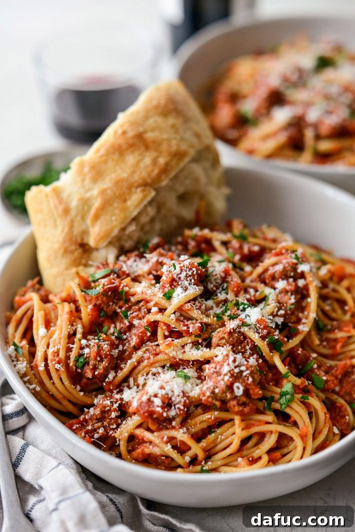 Slow Roasted Spaghetti Sauce 3 Delicious slow baked spaghetti sauce in a Dutch oven with pasta, garnished with fresh basil.