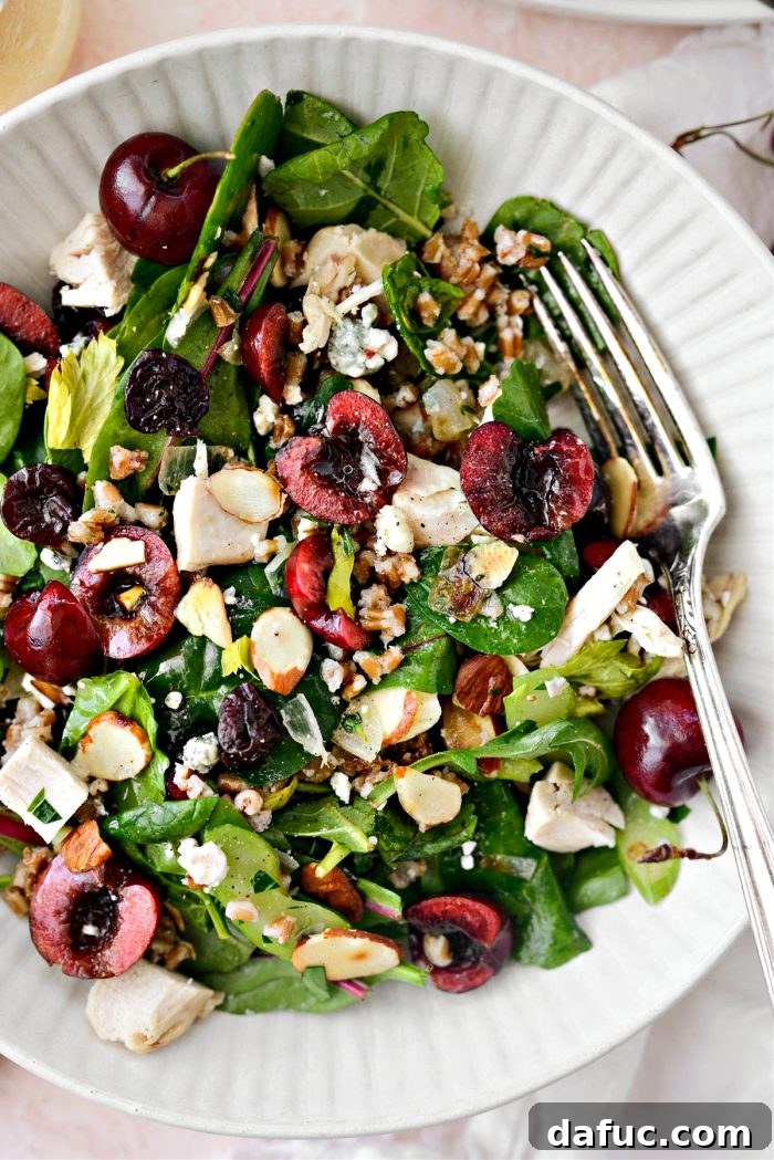 Cherry Winter Wheat Berry Salad with fresh and dried cherries, wheat berries, blue cheese, almonds, celery, onions, thyme, chicken, and power greens