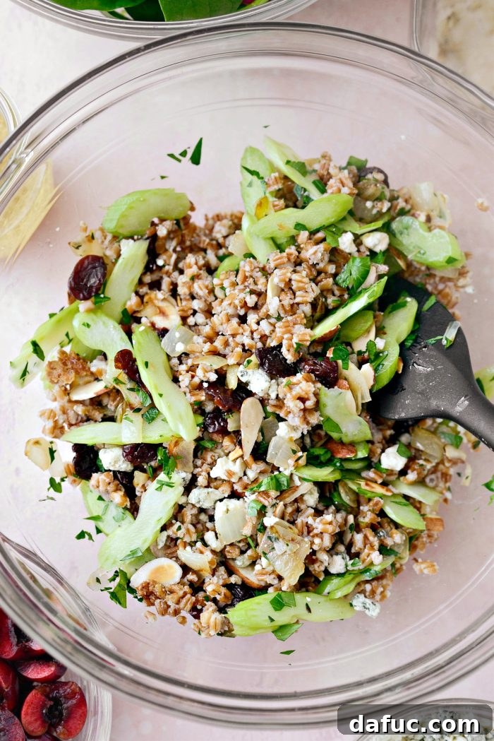 Tossing the salad ingredients in a large bowl to combine them evenly