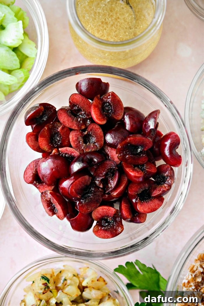 Fresh cherries being pitted and cut in half, showcasing their vibrant red color