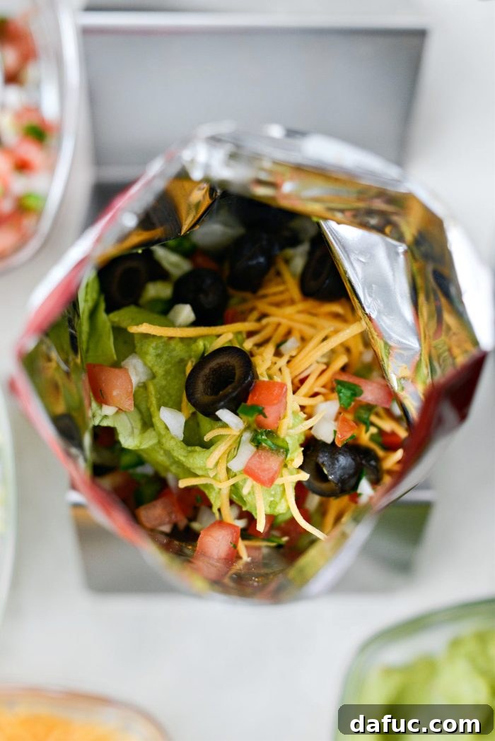 Walking Tacos Two Ways 13 Cheese, guacamole, and black olives added to the walking taco bag.