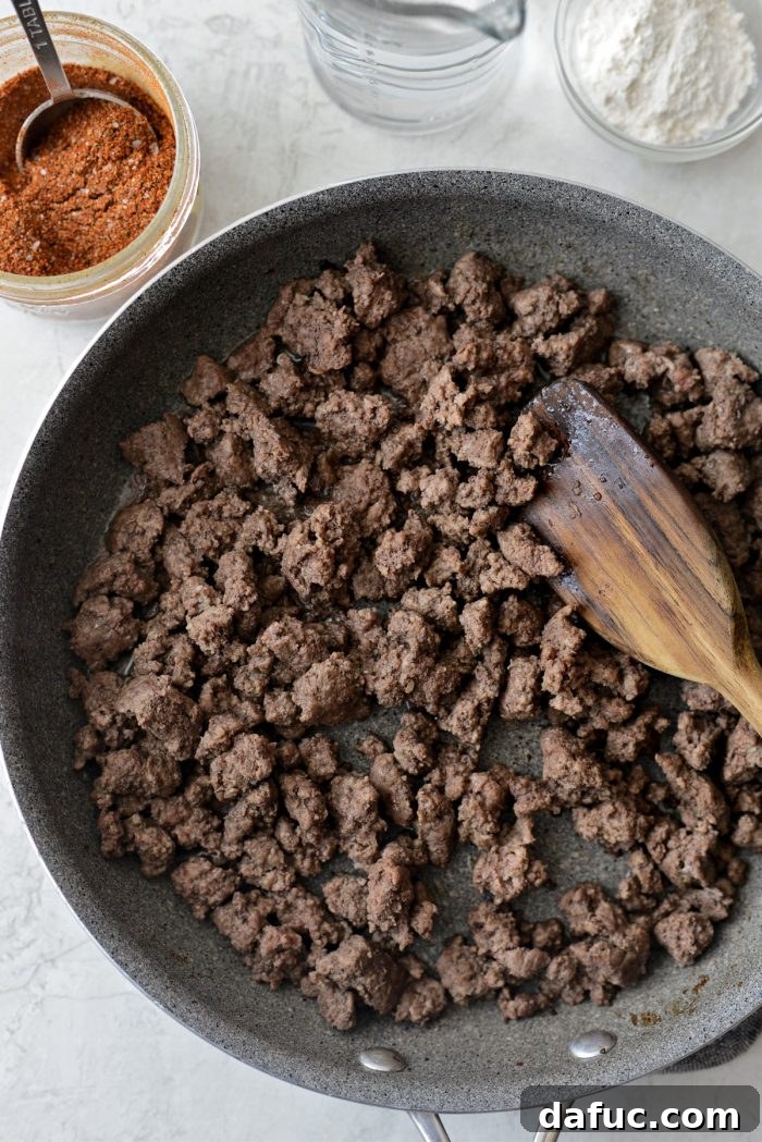 Walking Tacos Two Ways 4 Ground beef browning in a skillet.