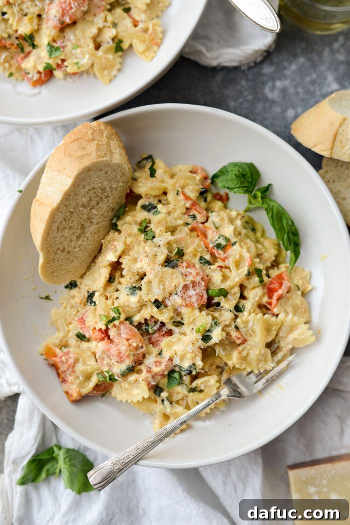 Blistered Tomato Feta Pasta 20 A bowl of freshly made Baked Feta Pasta with Burst Cherry Tomatoes, garnished with Parmesan