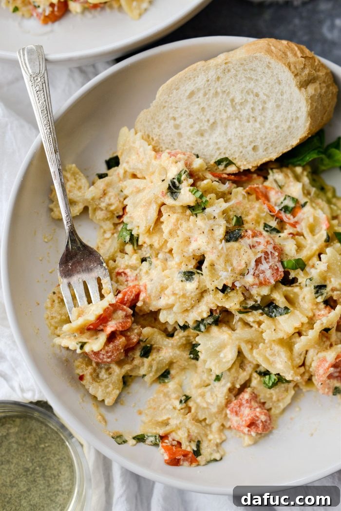 Blistered Tomato Feta Pasta 21 Close-up of a serving of Baked Feta Pasta with Burst Cherry Tomatoes and fresh basil