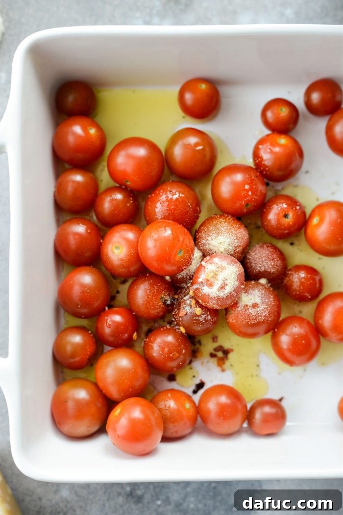 Blistered Tomato Feta Pasta 8 Seasoning cherry tomatoes with salt, pepper, onion powder, and red pepper flakes