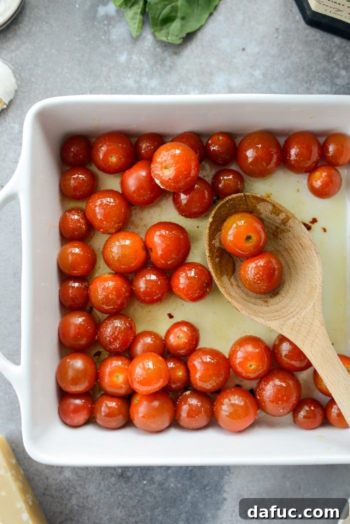 Blistered Tomato Feta Pasta 9 Tossing cherry tomatoes with seasonings in a baking dish