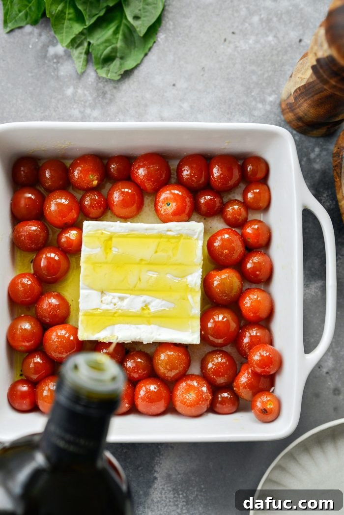 Blistered Tomato Feta Pasta 10 Adding a block of feta cheese to the center of the baking dish with tomatoes