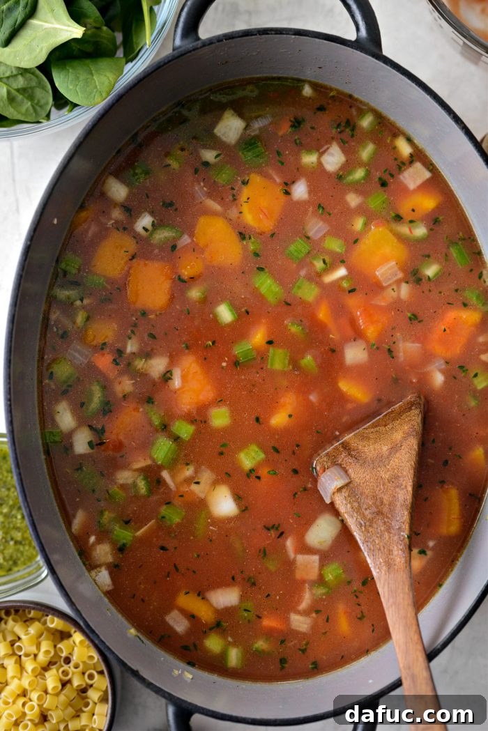 Ina Garten's Cozy Winter Minestrone 11 Soup simmering in a pot