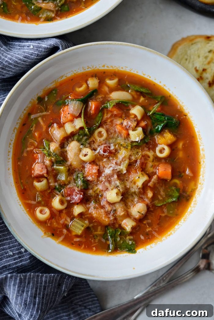 Ina Garten's Cozy Winter Minestrone 21 Ina Garten's Winter Minestrone served in a bowl with parmesan