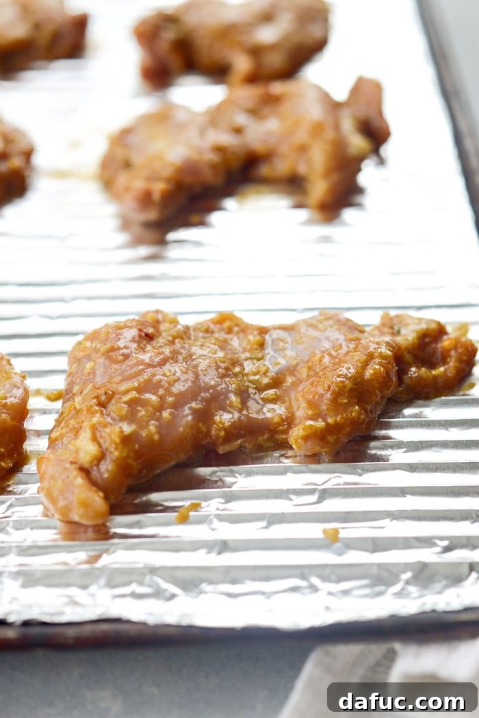 Aromatic Lemongrass Chicken 9 Marinated chicken on a foil-lined baking pan