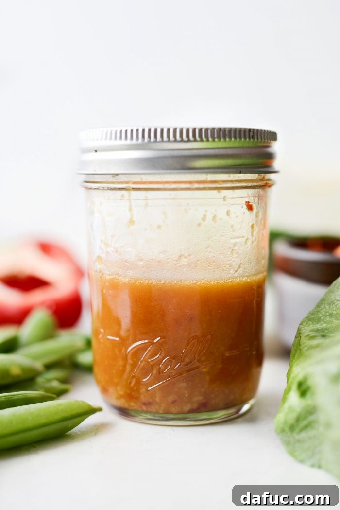 Zesty Thai Cabbage Slaw 6 Ingredients for the Thai dressing mixed together in a jar.