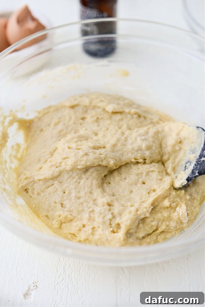 Close-up of the smooth, thick batter for Glazed Buttermilk Cake Doughnuts, ready for baking.