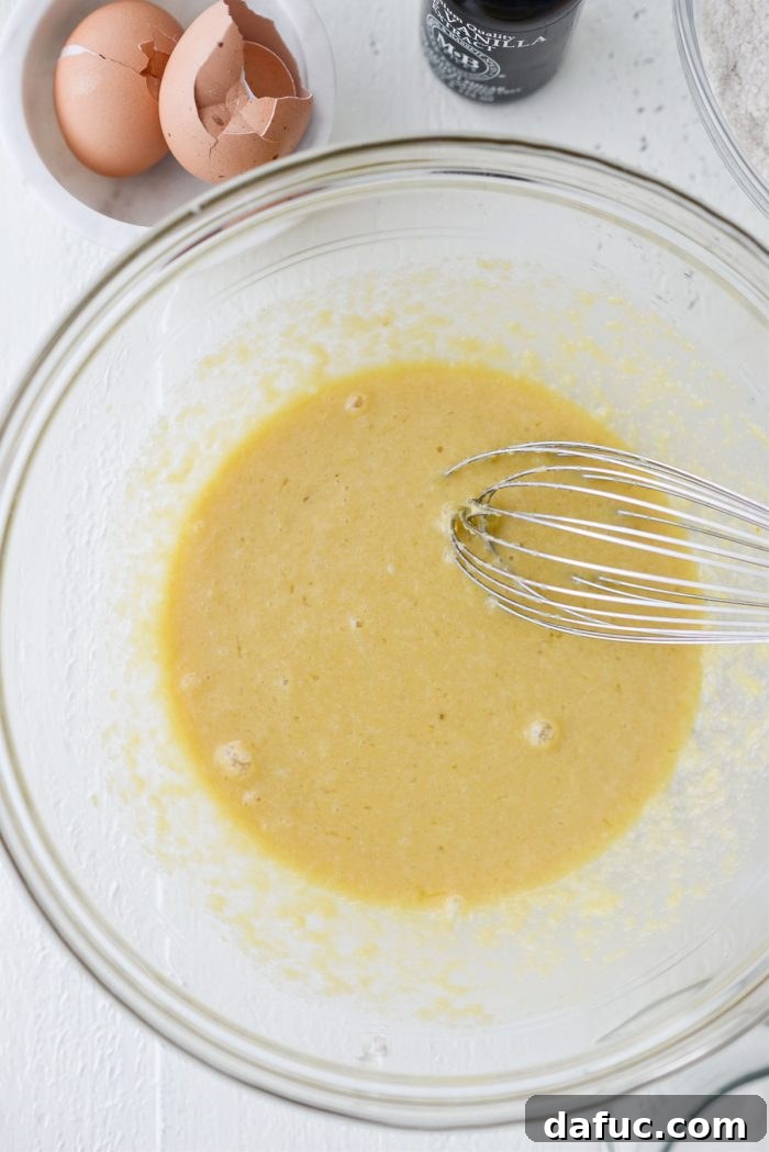 All wet ingredients (eggs, applesauce, butter, vanilla) thoroughly combined in a mixing bowl.
