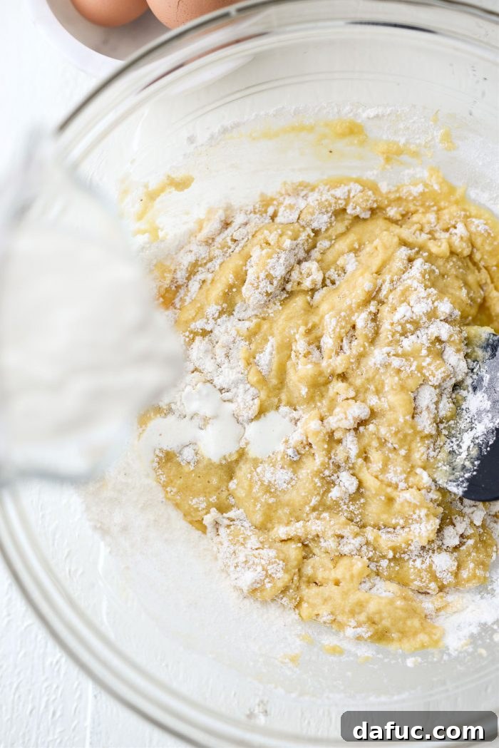 The process of alternately adding dry ingredients and buttermilk to the wet mixture, ensuring proper incorporation.