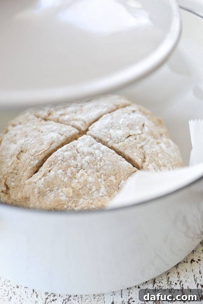 Hearty Irish Hearth Bread 12 Dutch oven with Irish Soda Bread dough inside, covered and baking in the oven
