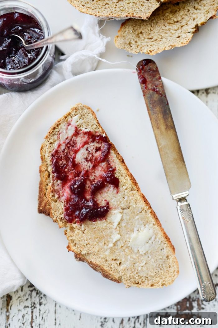 Hearty Irish Hearth Bread 18 Close-up of a slice of Irish Soda Bread with butter and jam