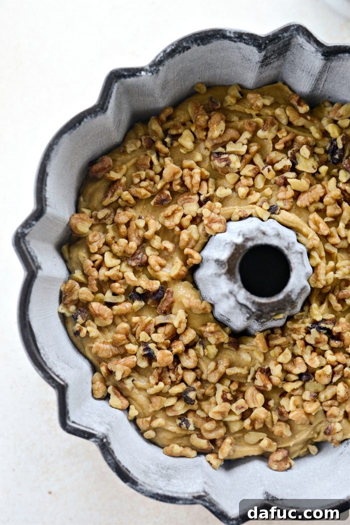 Emerald Isle Whiskey Cake 18 Chopped nuts sprinkled over the cake batter in the bundt pan