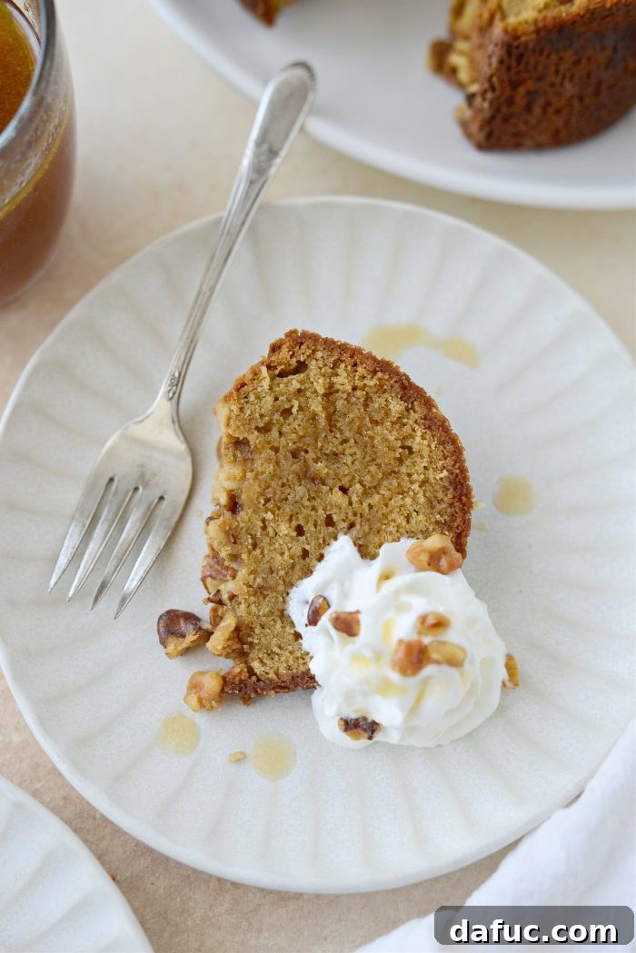 Emerald Isle Whiskey Cake 3 Close-up of a slice of Irish Whiskey Cake with extra glaze and whipped cream