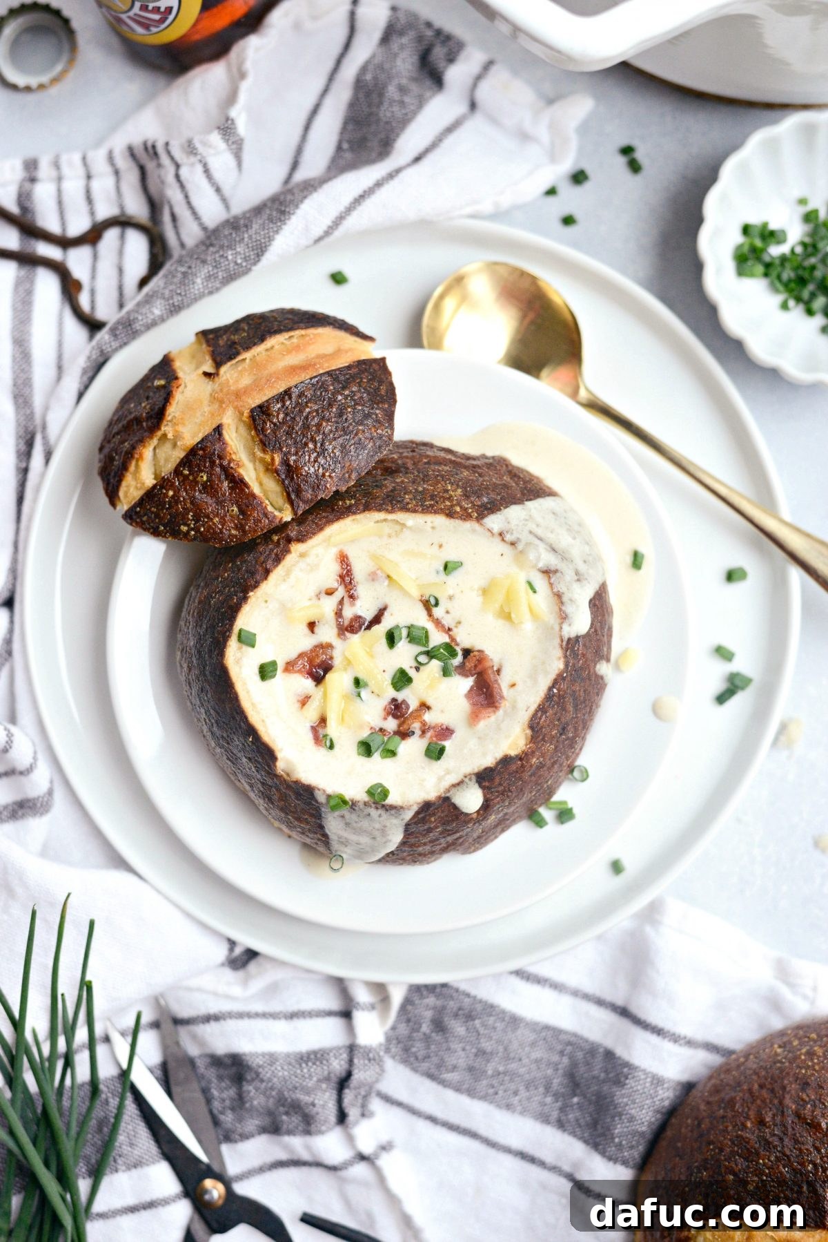 25+ Delicious St. Patrick's Day Recipes 11 Rich Irish Cheddar Beer Soup in a homemade pretzel bread bowl, garnished with bacon and chives