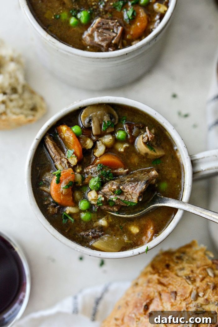 25+ Delicious St. Patrick's Day Recipes 13 Bowl of Vegetable Beef and Barley Soup with herbs and hearty vegetables