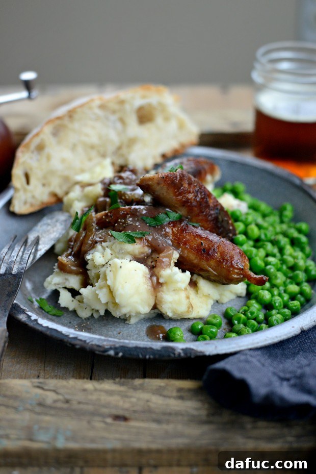 25+ Delicious St. Patrick's Day Recipes 24 Classic Irish Bangers and Mash with rich caramelized onion gravy, served with peas