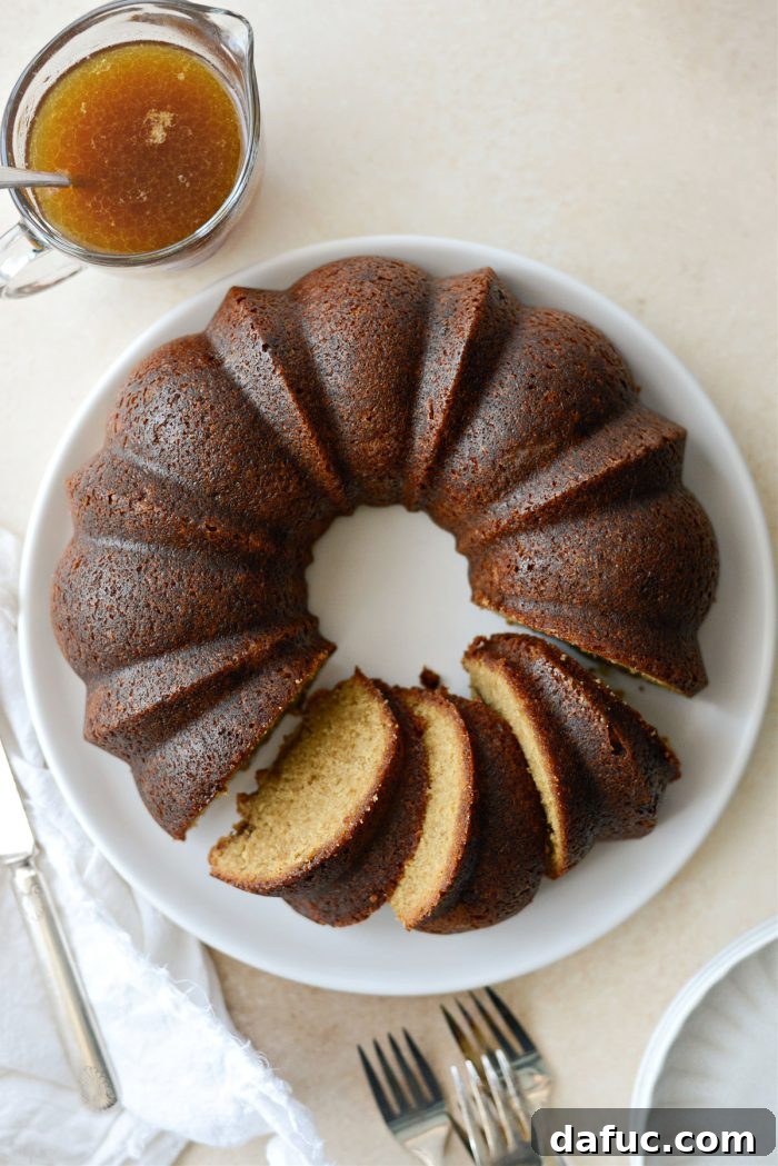 25+ Delicious St. Patrick's Day Recipes 26 Elegant Irish Whiskey Cake with a glaze and a dollop of whipped cream on top