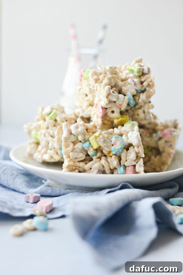 25+ Delicious St. Patrick's Day Recipes 30 Colorful Lucky Charms Marshmallow Treats on a serving platter, a fun St. Patrick's Day dessert