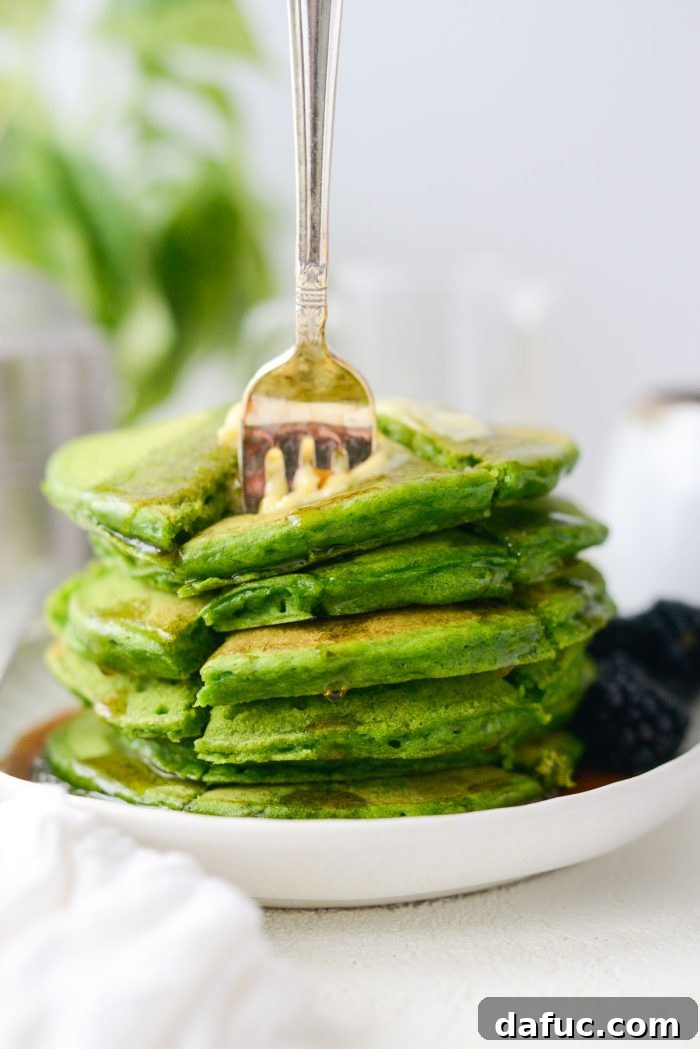 25+ Delicious St. Patrick's Day Recipes 4 Stack of bright green pancakes, naturally colored with spinach, drizzled with maple syrup