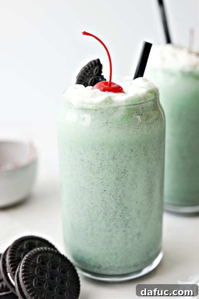 25+ Delicious St. Patrick's Day Recipes 34 Cookies and Cream Shamrock Shakes with whipped cream and cookie crumbs in tall glasses