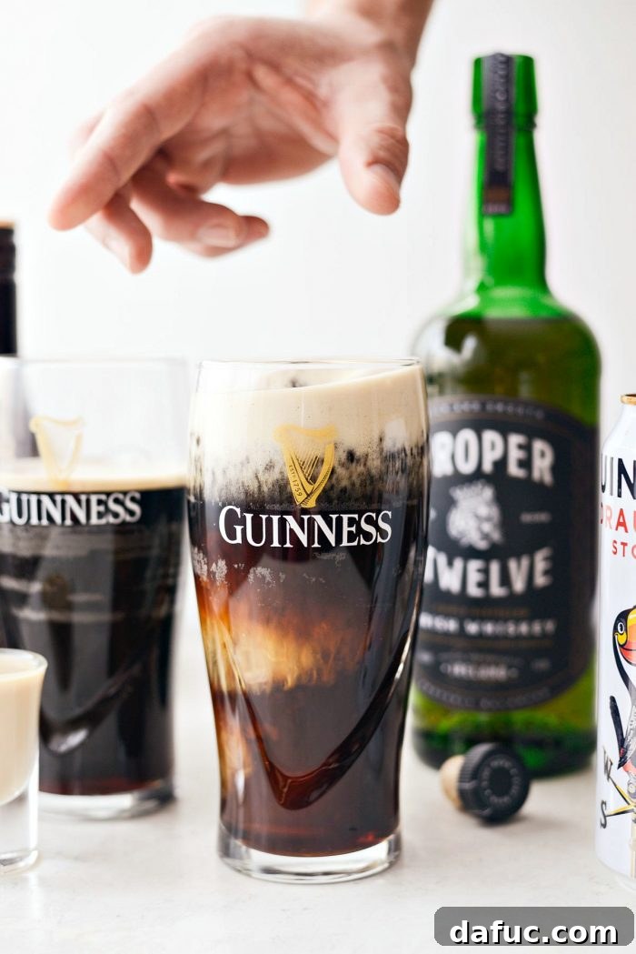 25+ Delicious St. Patrick's Day Recipes 36 Irish Slammer drink with a shot glass dropping into a pint of Guinness stout