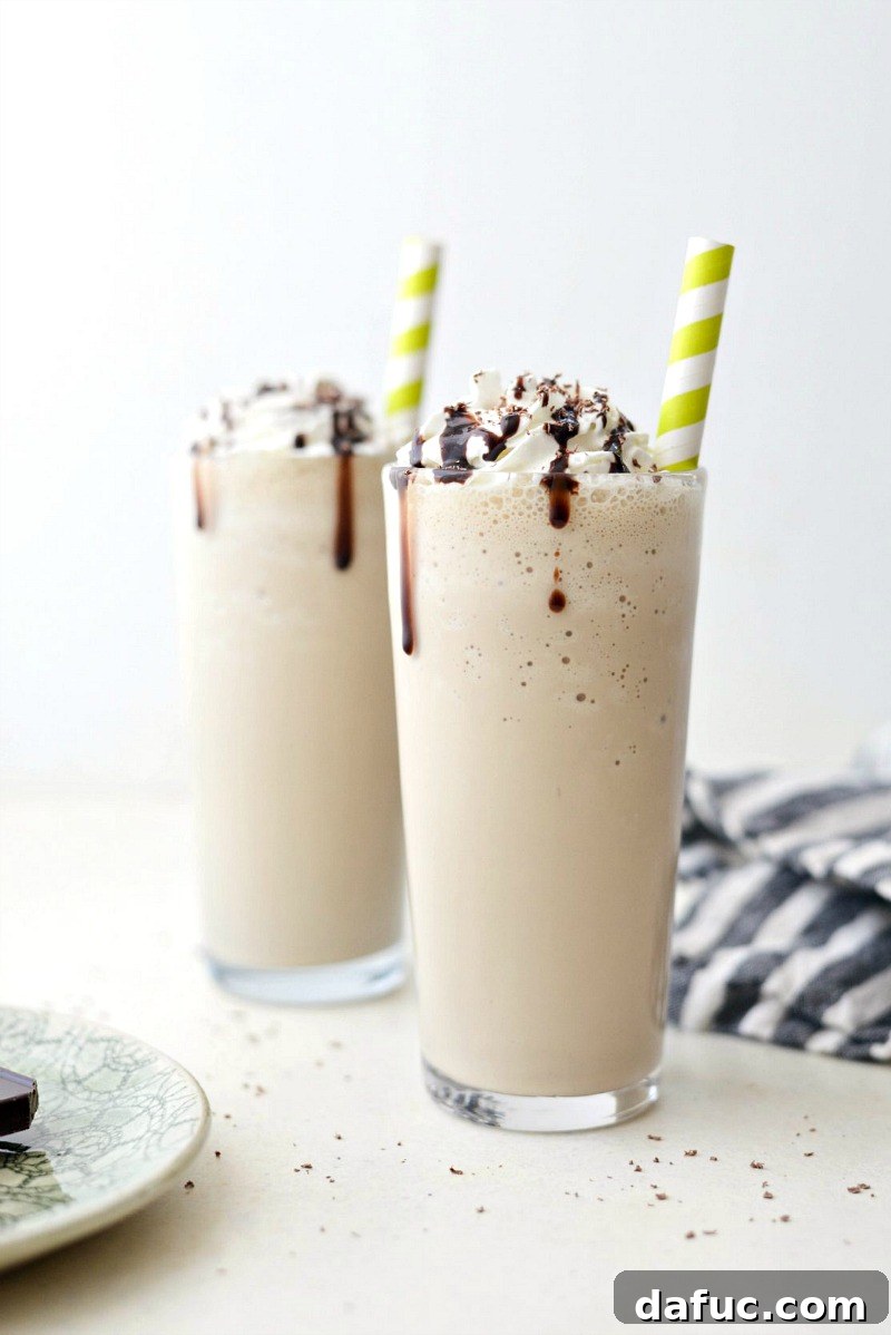 25+ Delicious St. Patrick's Day Recipes 37 Boozy Bailey's and Coffee Milkshake topped with whipped cream and chocolate shavings in a tall glass