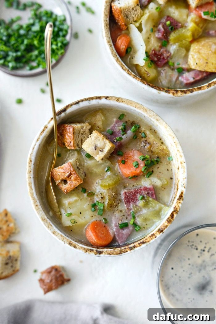 25+ Delicious St. Patrick's Day Recipes 38 Hearty Corned Beef and Cabbage Chowder in a bowl, garnished with chives