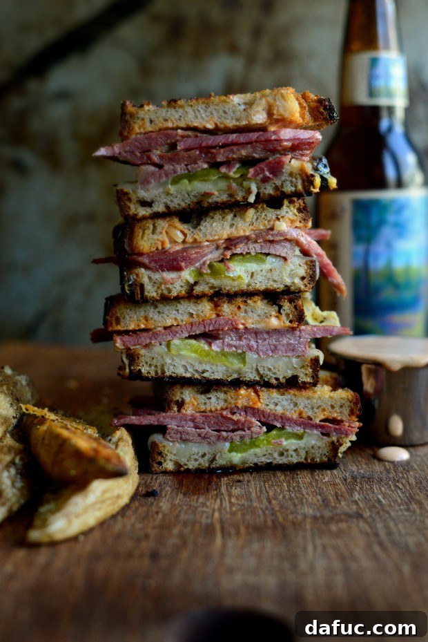 25+ Delicious St. Patrick's Day Recipes 42 Grilled Corned Beef Sandwich on rye bread with cheese, Russian dressing, and pickles