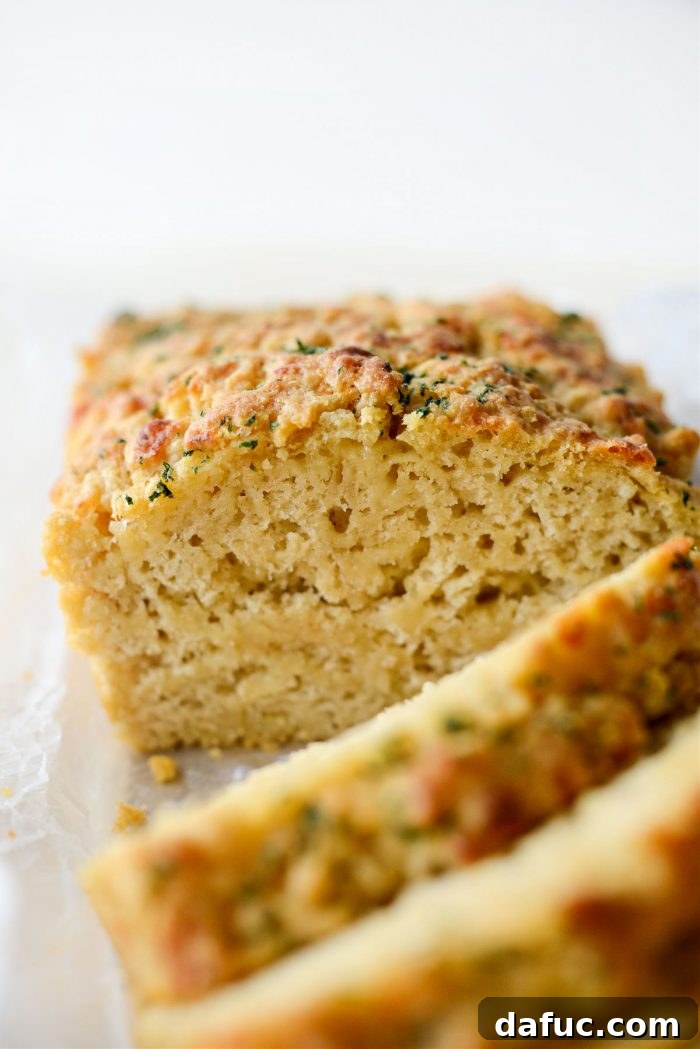 25+ Delicious St. Patrick's Day Recipes 7 Slice of Irish Ale and Cheddar Bread showing its moist texture and specks of cheese