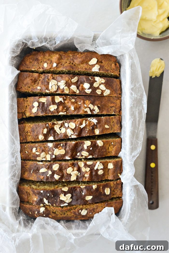 25+ Delicious St. Patrick's Day Recipes 8 Traditional Irish Brown Bread loaf on a wooden cutting board, ready to be sliced