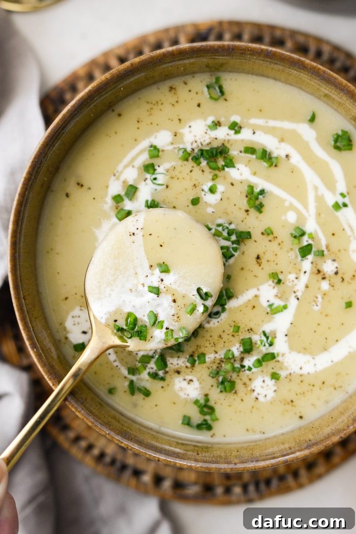 25+ Delicious St. Patrick's Day Recipes 9 Bowl of creamy potato leek soup garnished with fresh chives and a swirl of cream