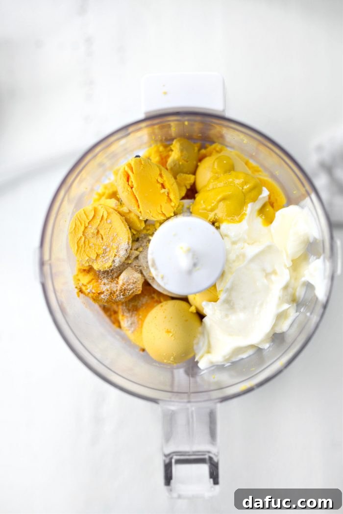 add yolks, mayo, mustard, pickle juice, salt, white pepper and turmeric to mini food processor.