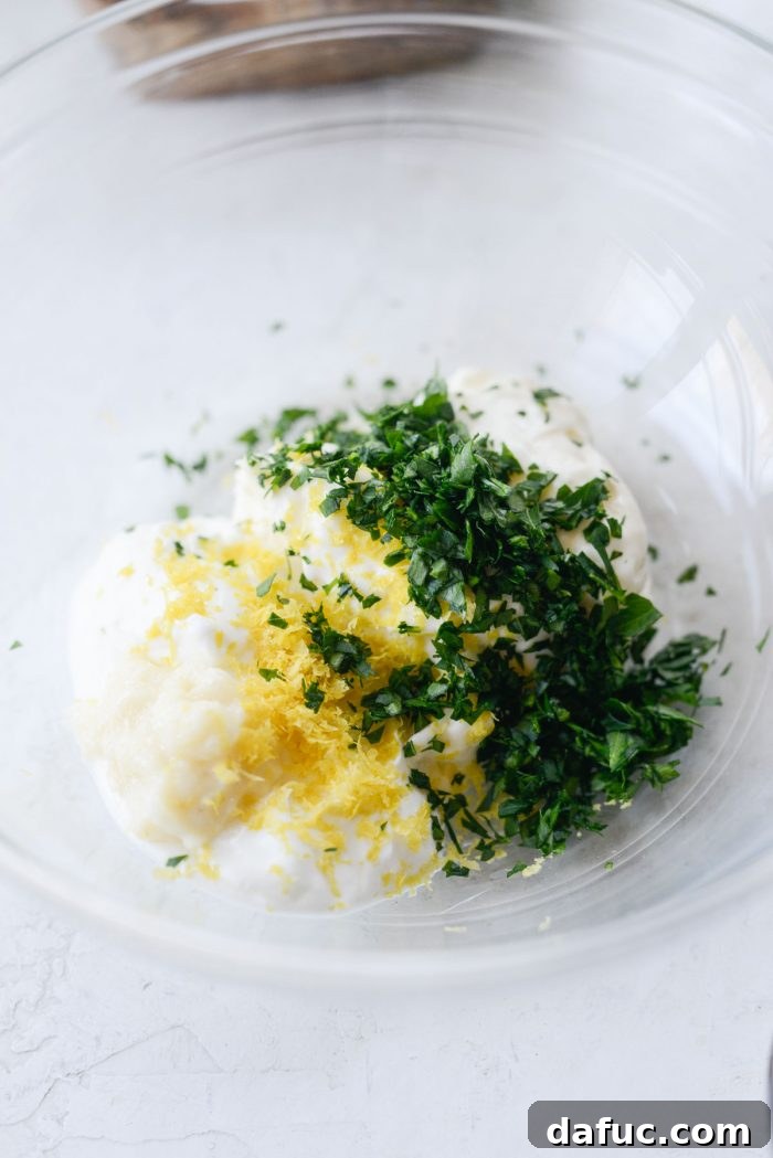 Sun-Kissed Tuna Medley 4 mayo, greek yogurt, garlic paste, lemon zest and parsley in a bowl