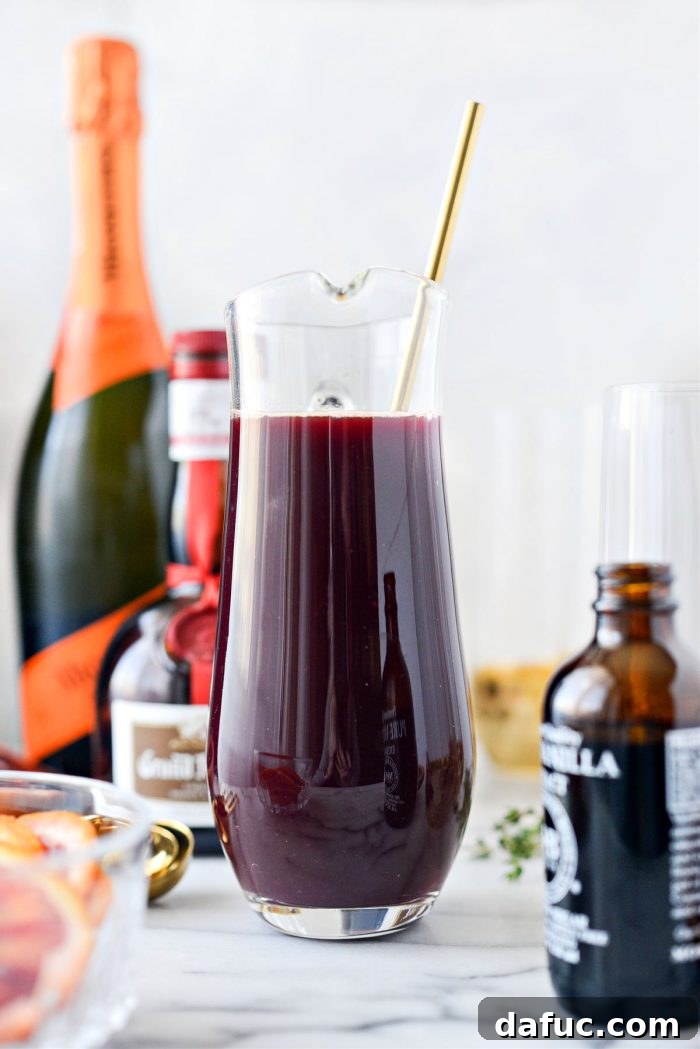 Velvet Vanilla Blood Orange Mimosas 7 Close-up of vanilla blood orange juice being stirred