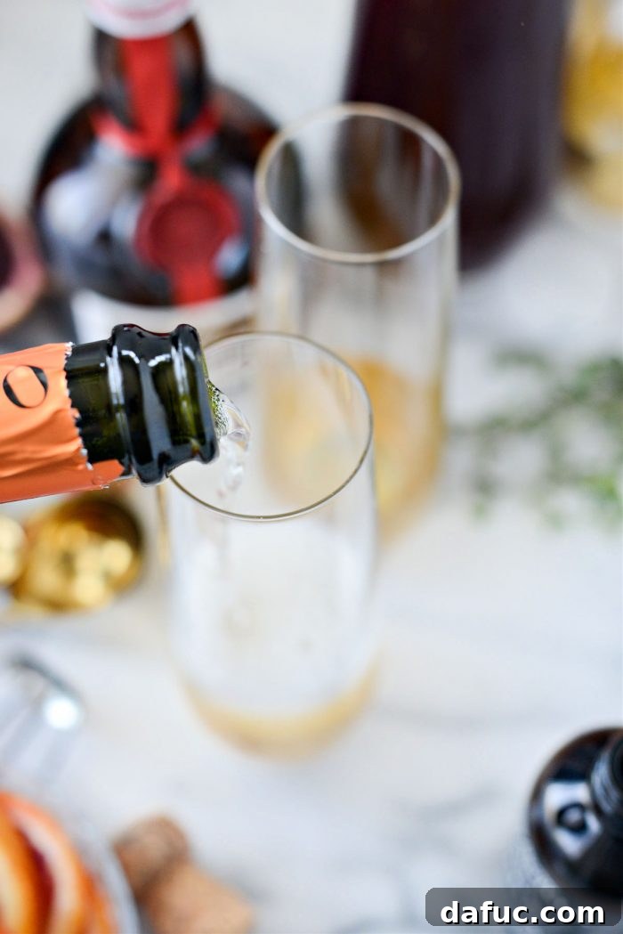 Velvet Vanilla Blood Orange Mimosas 9 Prosecco being poured into a champagne flute