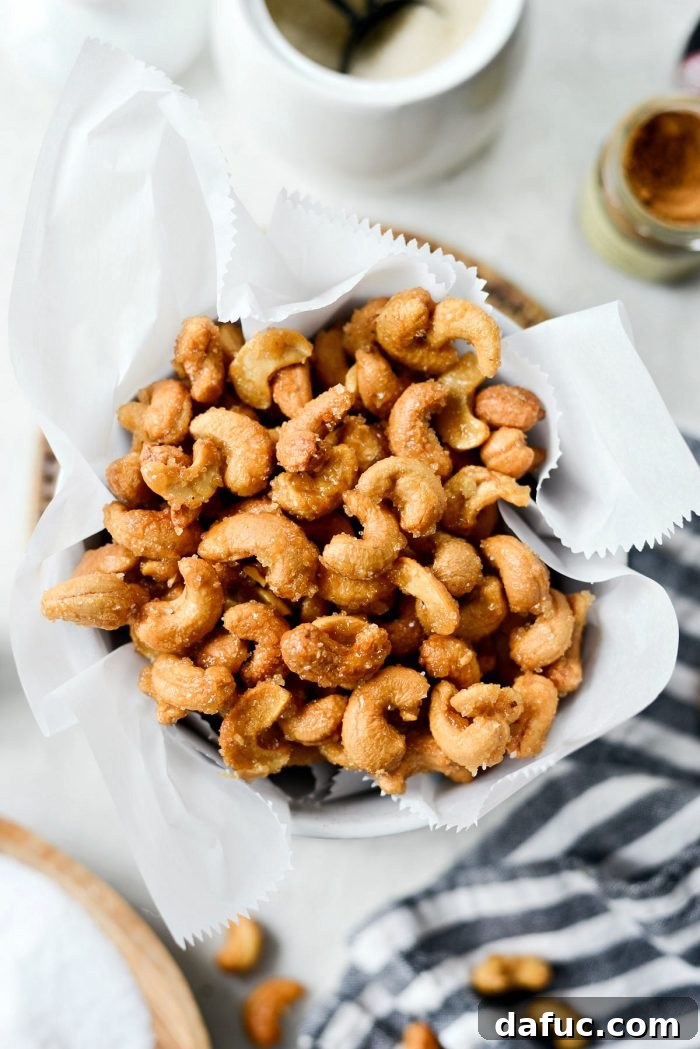 Decadent Honey Roasted Cashews 2 Golden brown honey roasted cashews in a bowl, a perfect sweet and salty snack.