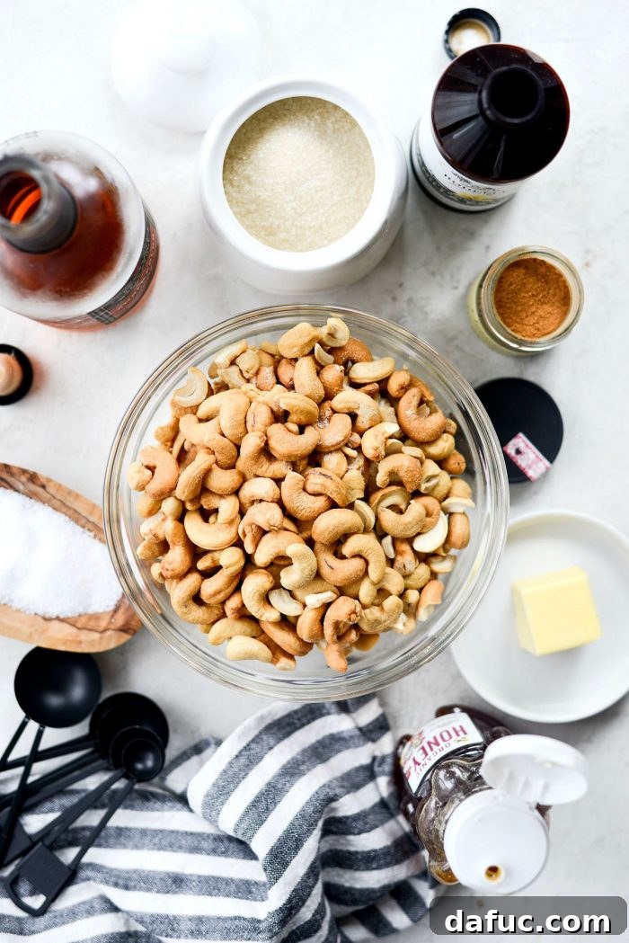 Decadent Honey Roasted Cashews 4 Ingredients for honey roasted cashews laid out on a white surface.