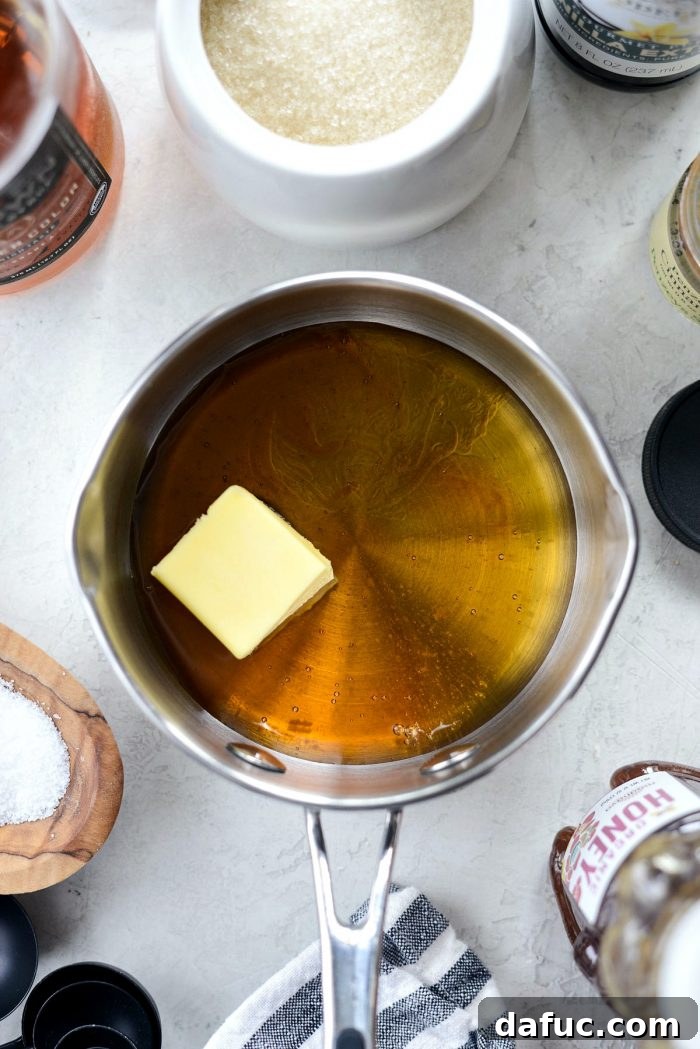 Decadent Honey Roasted Cashews 5 Small saucepan with honey, maple syrup, and butter melting.