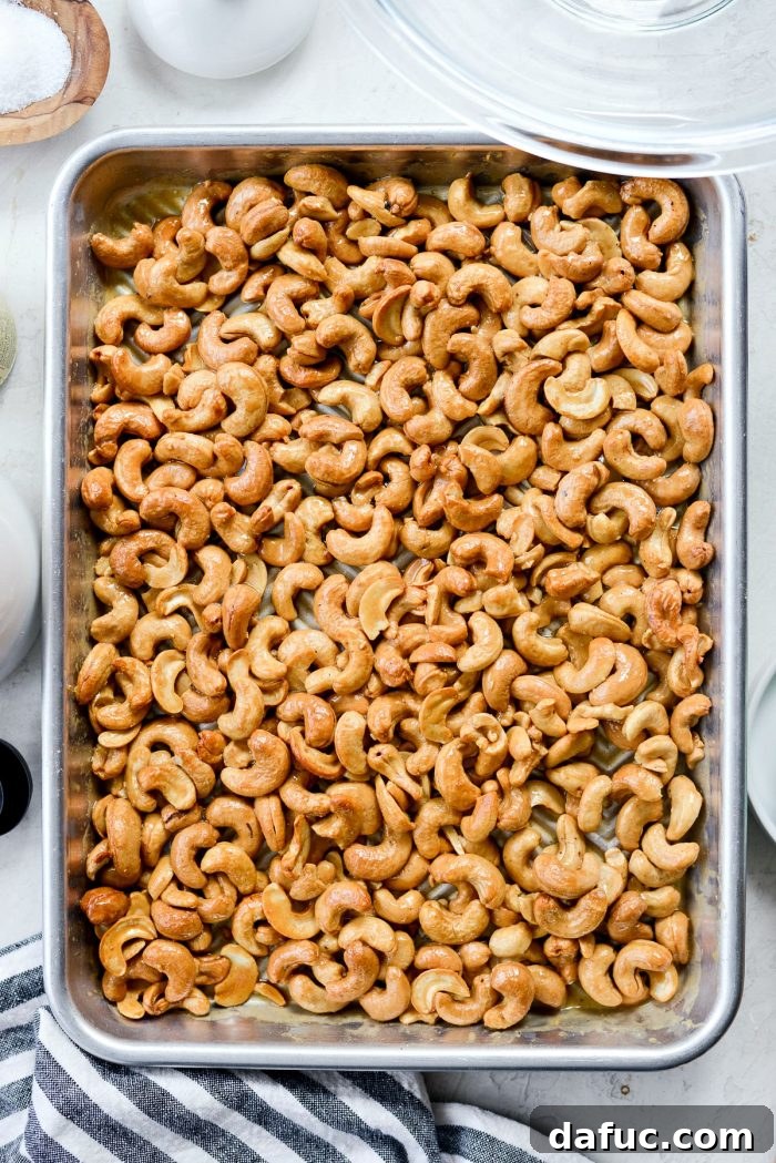 Decadent Honey Roasted Cashews 9 Honey roasted cashews baking in the oven, showing caramelization.