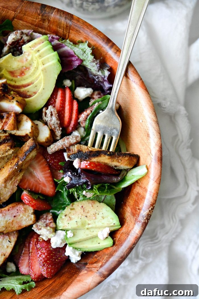 A forkful of Strawberry Goat Cheese Spring Salad being lifted, showing the delicious layers