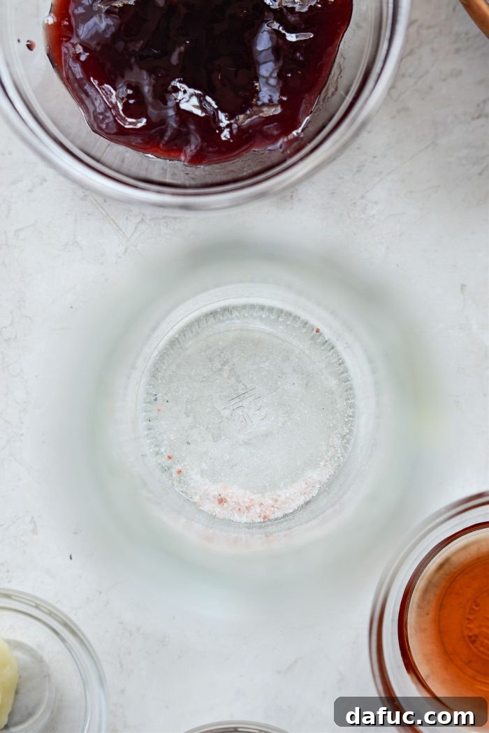 Fine salt being added to a jar for vinaigrette