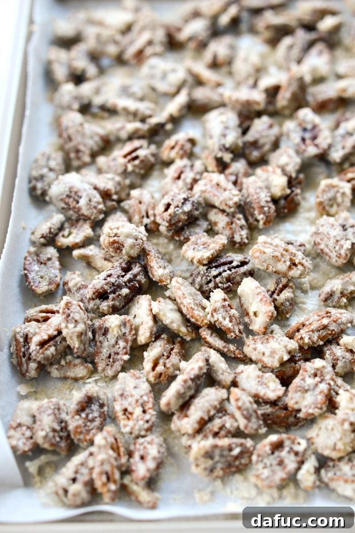A vibrant close-up of finished candied pecans, perfectly browned and crunchy